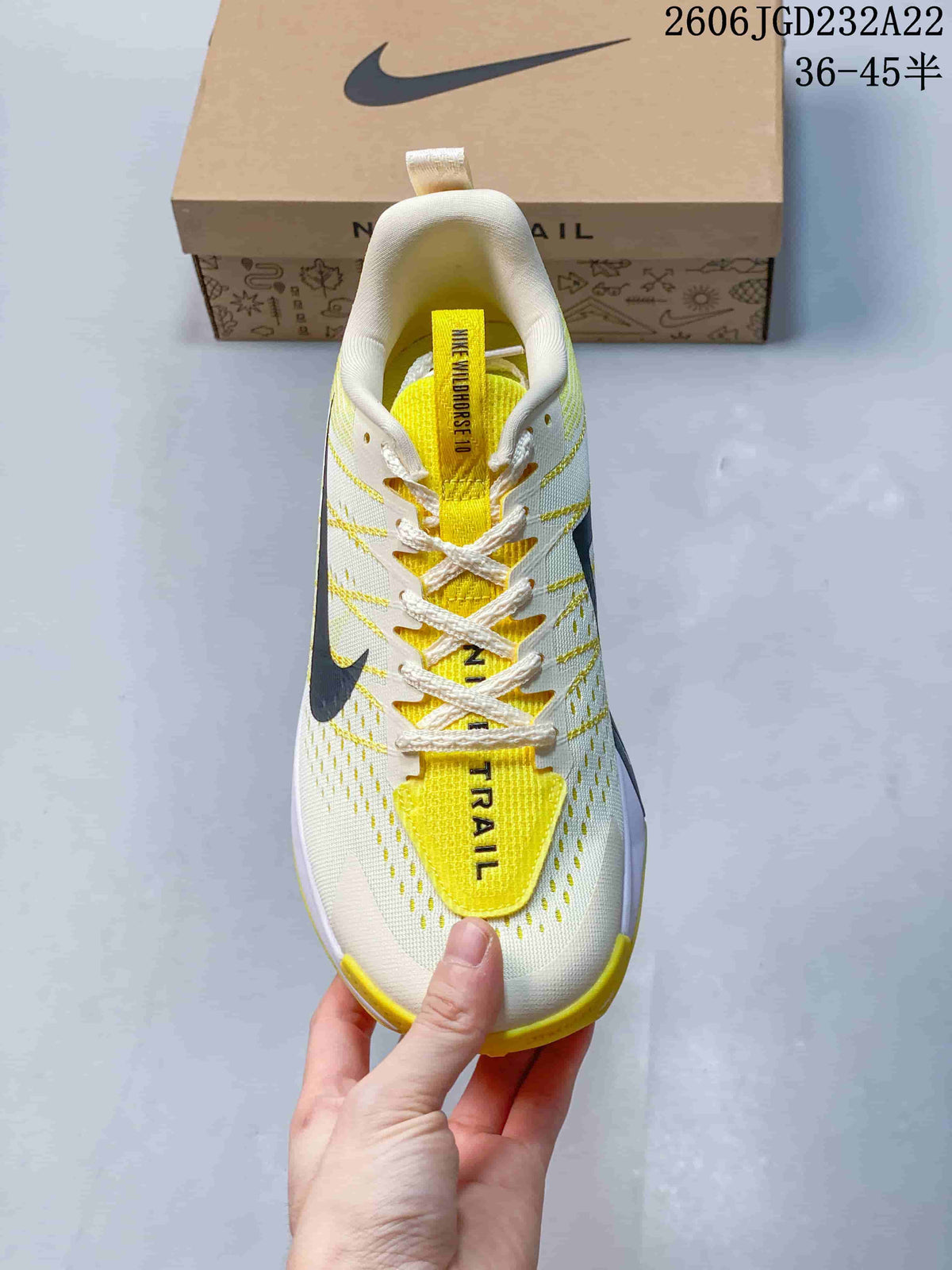 Top view showing the laces, yellow tongue, and perforated upper