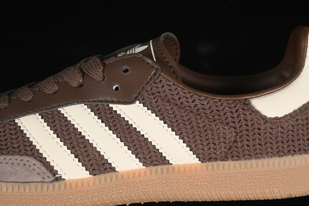 Close-up of brown upper, off-white stripes, lace panel and gum outsole