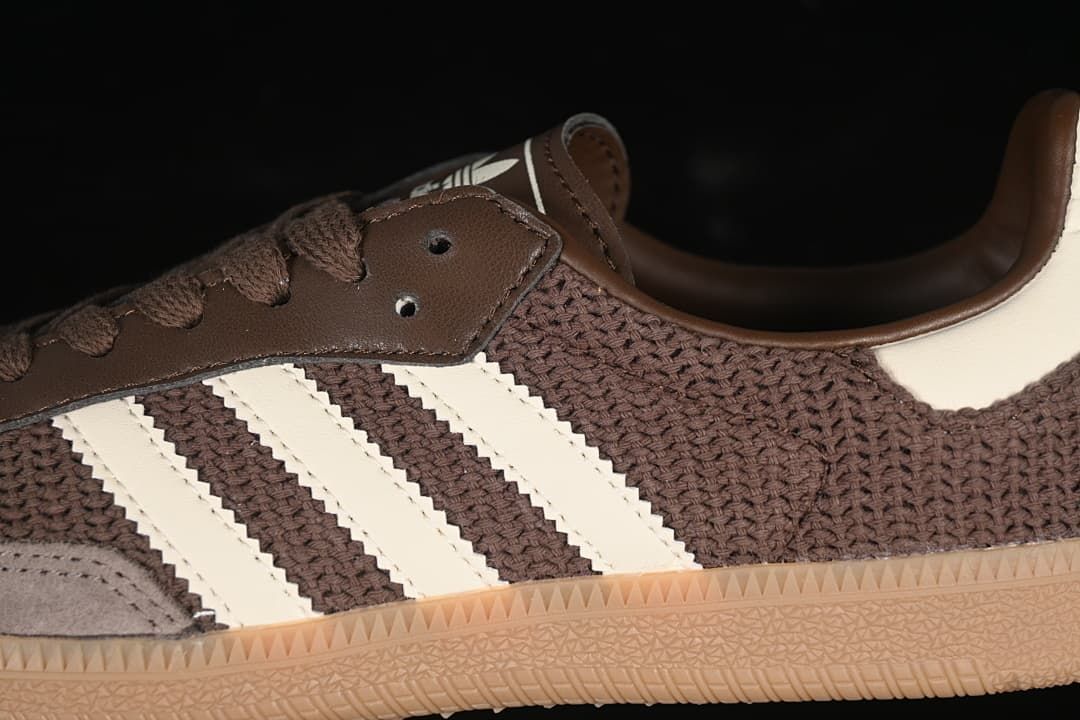 Close-up of brown upper, off-white stripes, lace panel and gum outsole