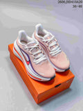 Pair of pink-toned Nike Air Zoom Winflo 12 shoes on an orange shoe box