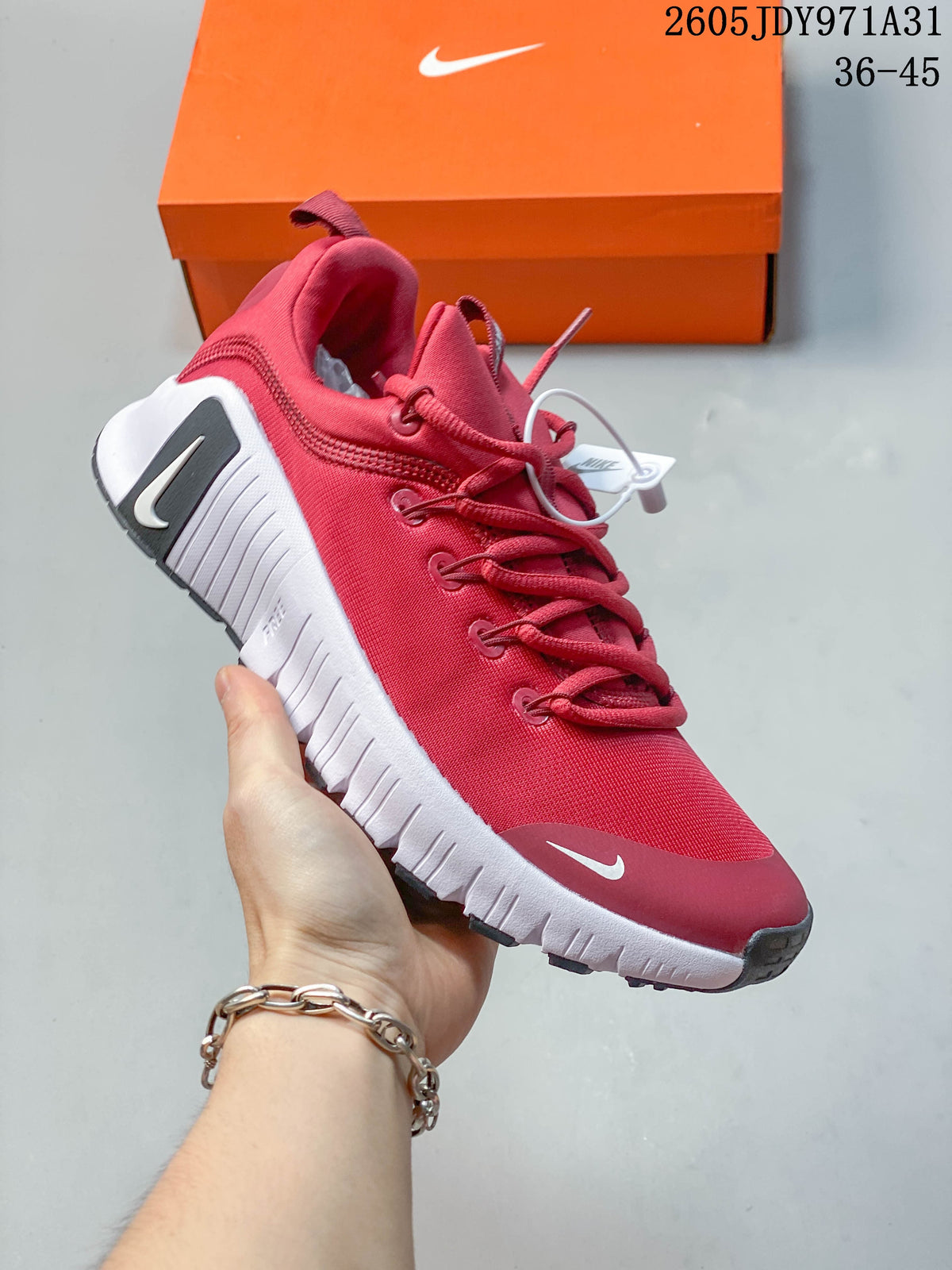 Angled side view of the red Nike Free Metcon 6 shoe with white sole and dark accents