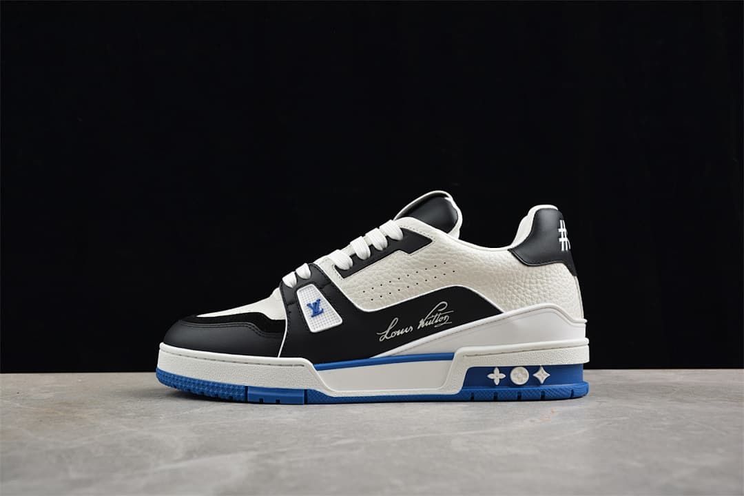 Side profile of a white, black, and blue LV Trainer sneaker