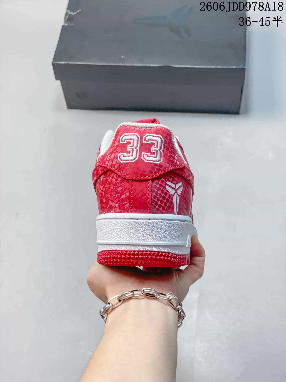 Rear view of a red patterned sneaker with a number 33 heel graphic
