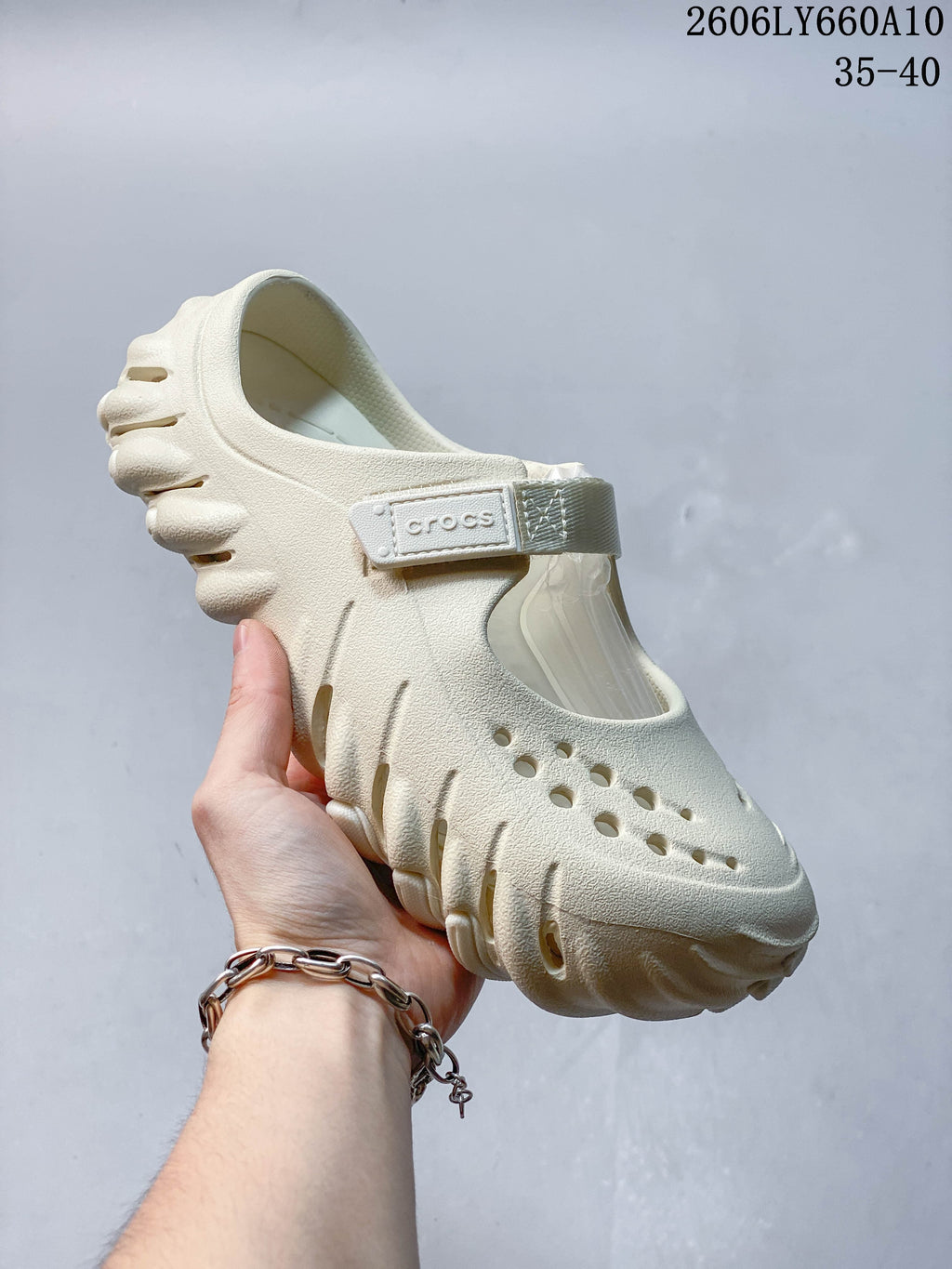 Side view of a cream Crocs Mary Jane-style clog showing its perforated upper, instep strap and sculpted sole.