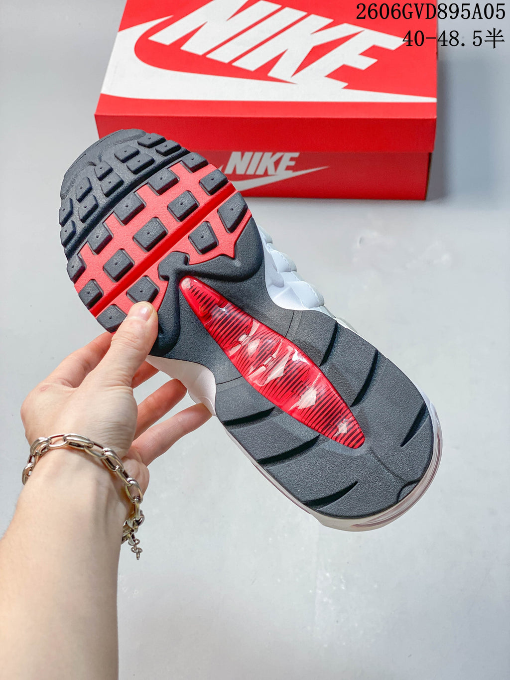 Close-up of the Nike Air Max 95 Big Bubble outsole with dark tread and a red center section.