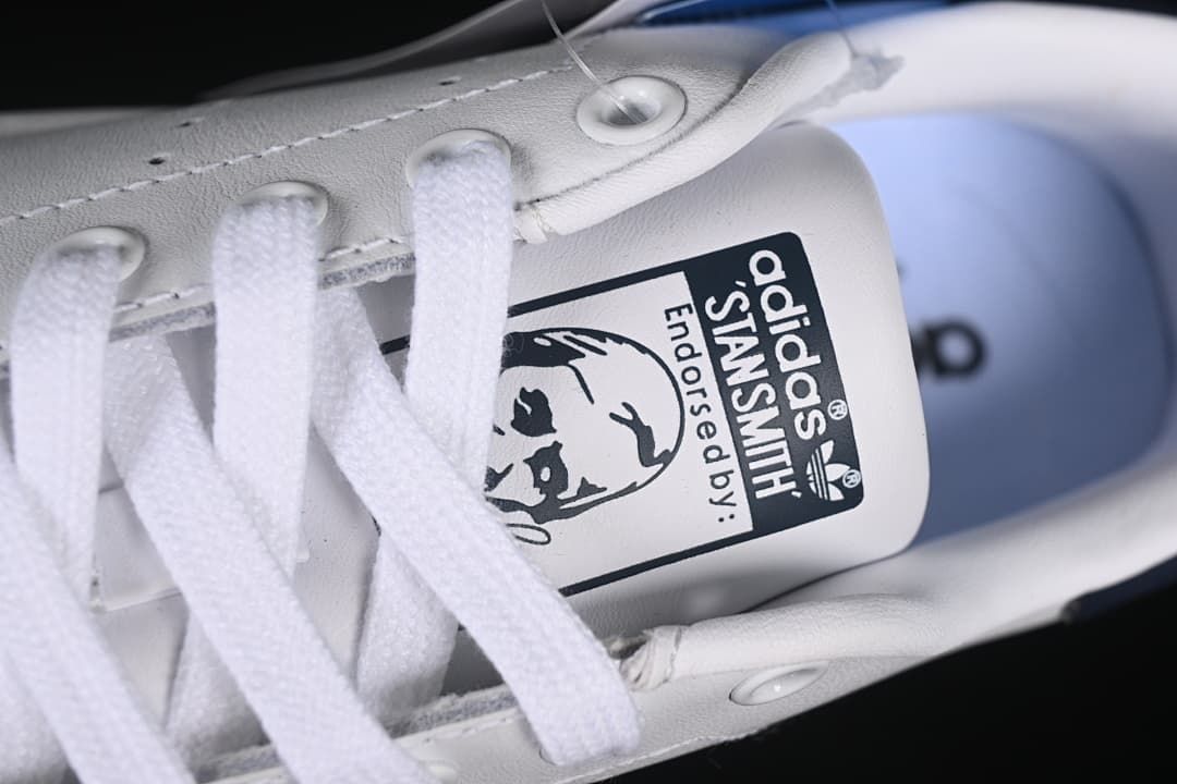 Close-up of the Stan Smith tongue label and white laces.