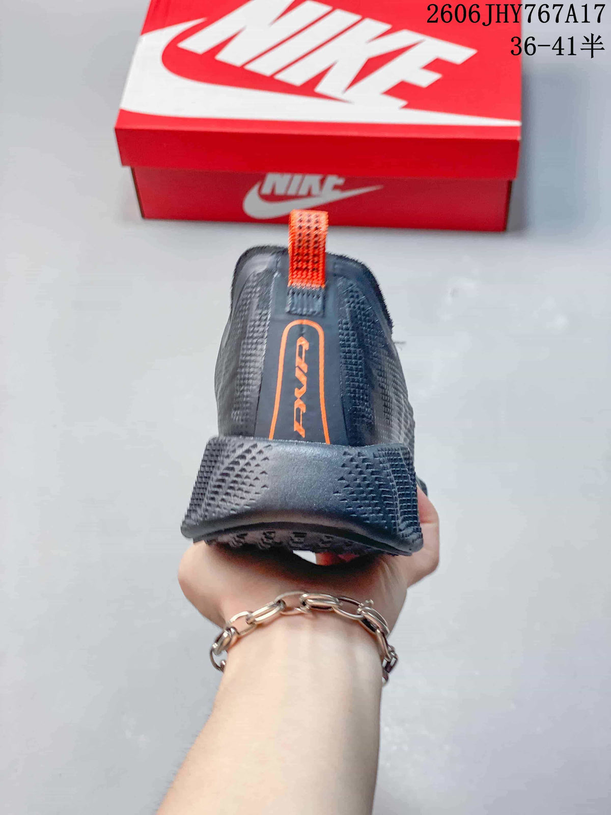 Rear view showing the heel structure and orange pull tab on a Nike Ava Rover sneaker.