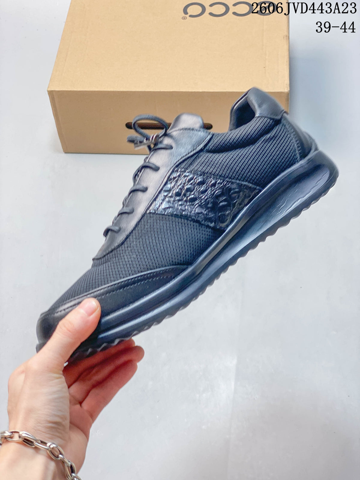 Side view of the navy sneaker with mesh-look panels and textured side accents
