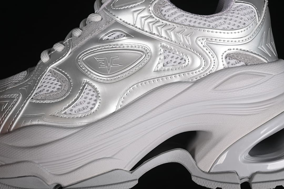 Close-up of the sneaker's silver-tone decorative panels and mesh-style sections.