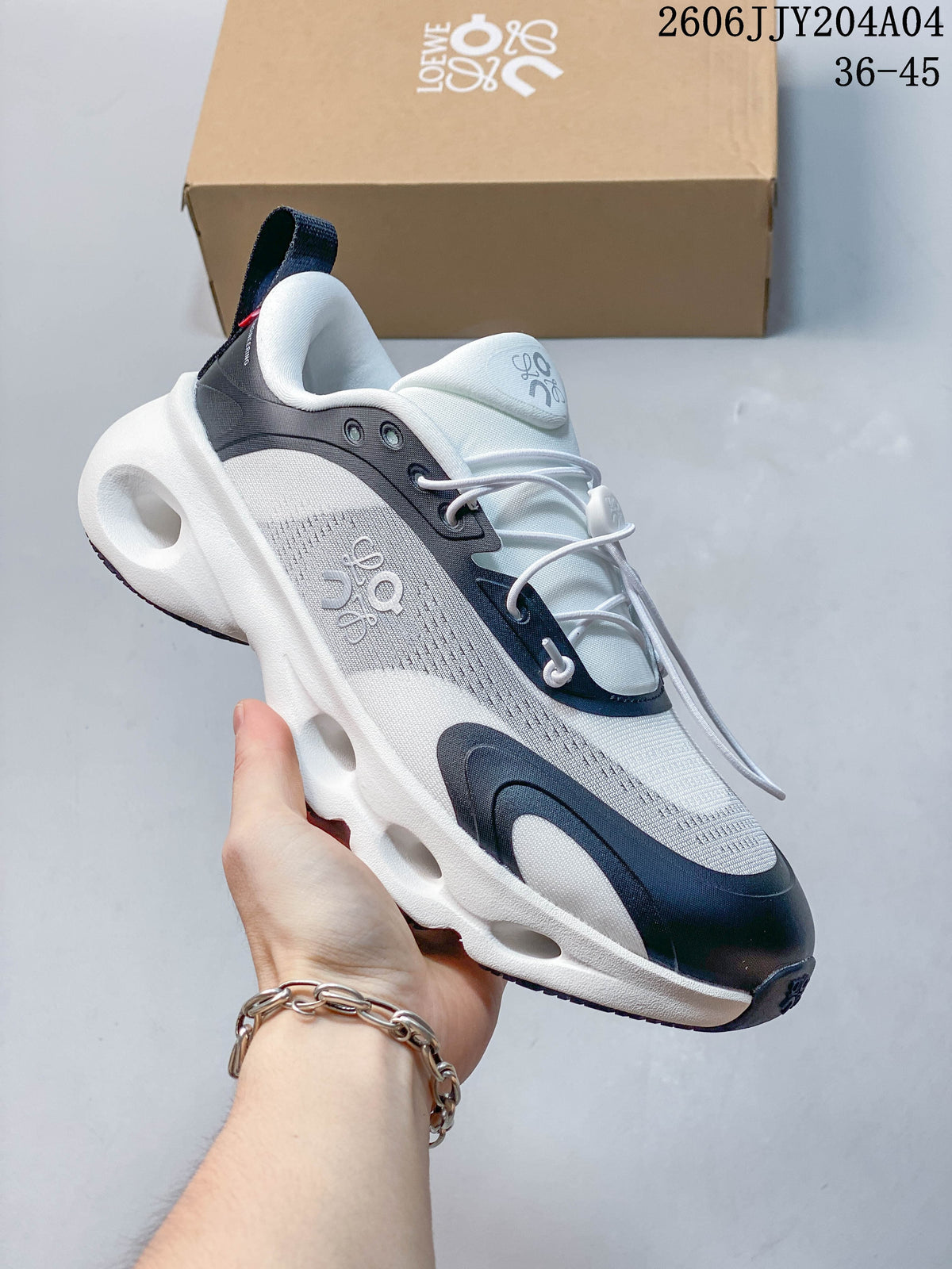 Side view of a white and navy sneaker with a heel pull tab