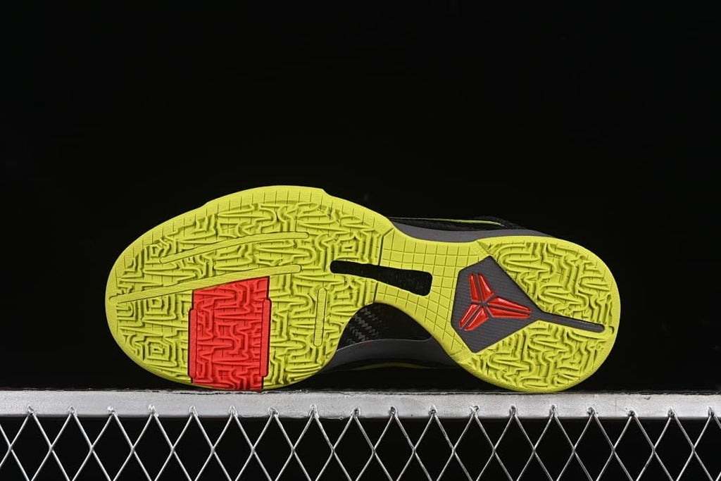 Bottom view showing the patterned yellow outsole and red traction section
