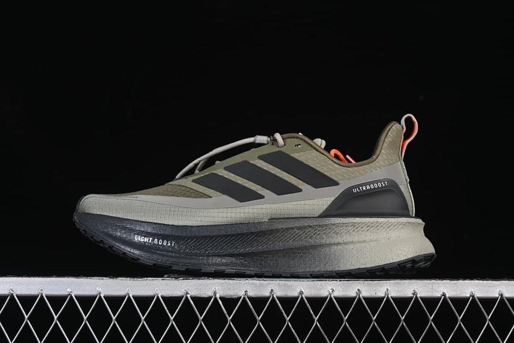 Side profile of olive and gray adidas Ultraboost 5 Climawarm shoes with dark stripes and orange accents