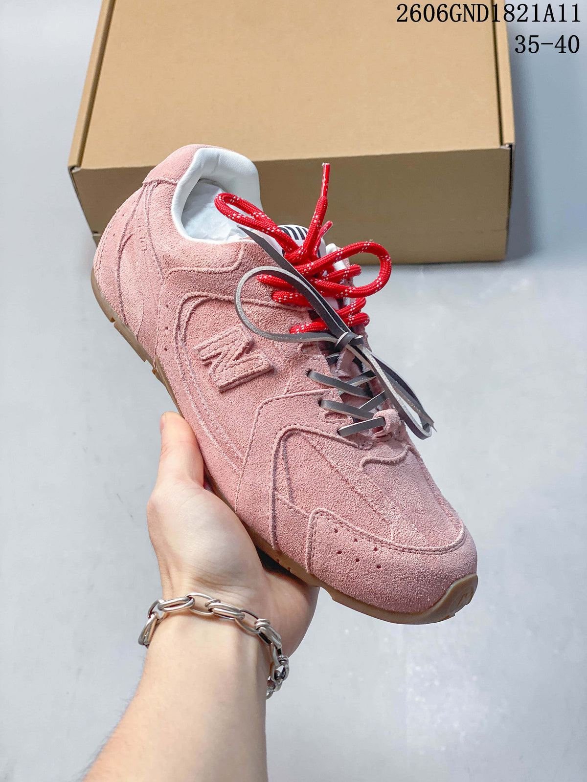 Angled view of a pink sneaker with layered panels and contrasting laces
