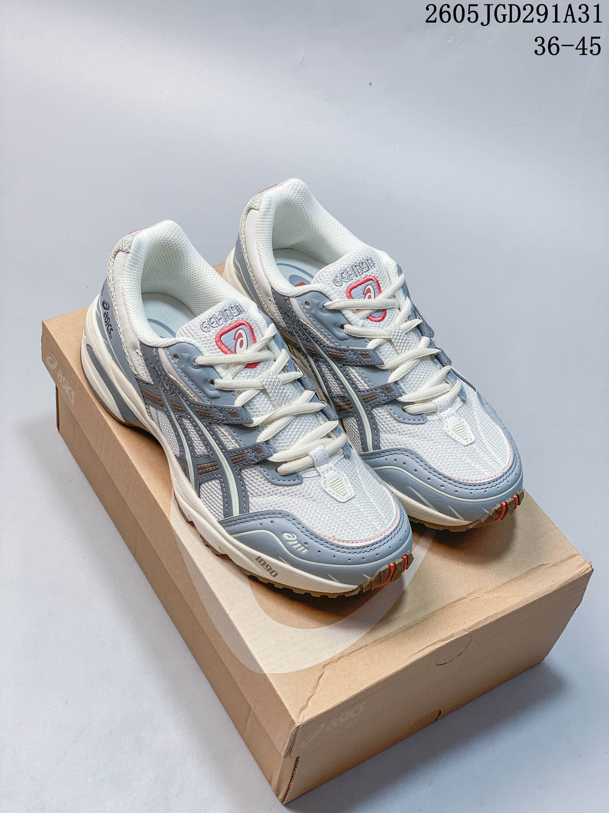 Pair of white and blue-gray ASICS lace-up sneakers with red accents, shown on a shoe box.