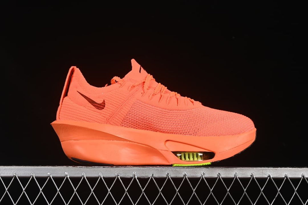 Side view showing the shoe's orange upper, dark Swoosh and sole
