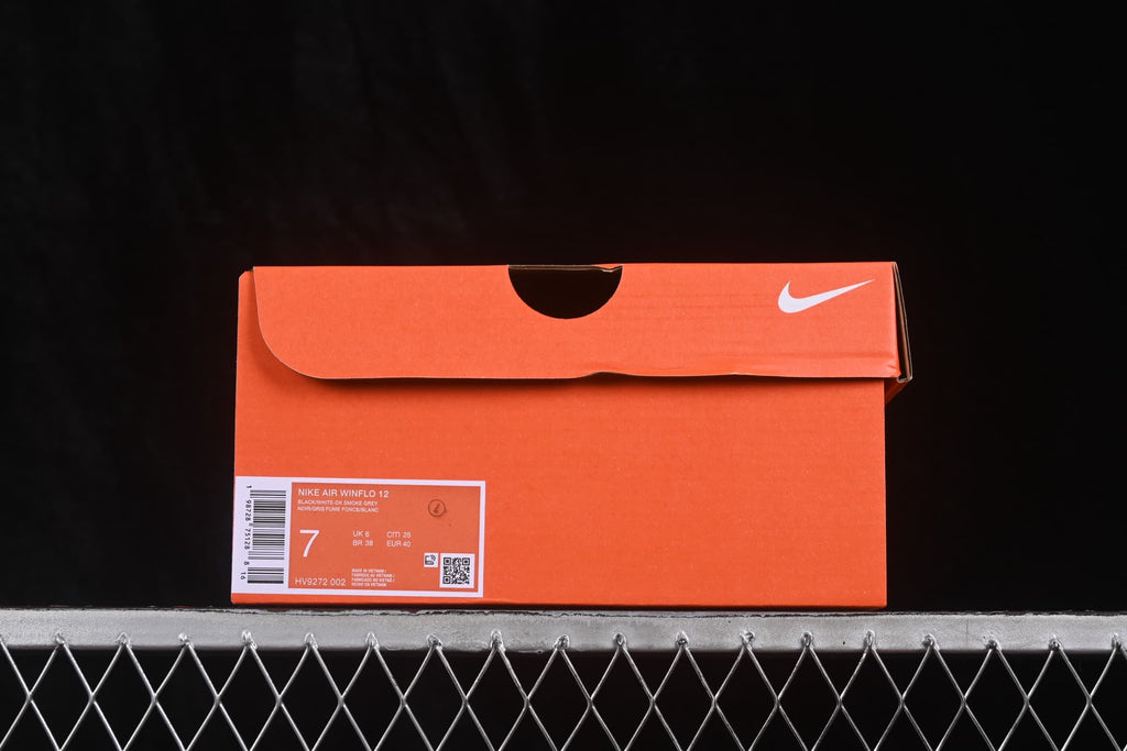 Orange Nike shoe box with a product label showing size US 7, EU 40, style code HV9272-002 and black-white color information.