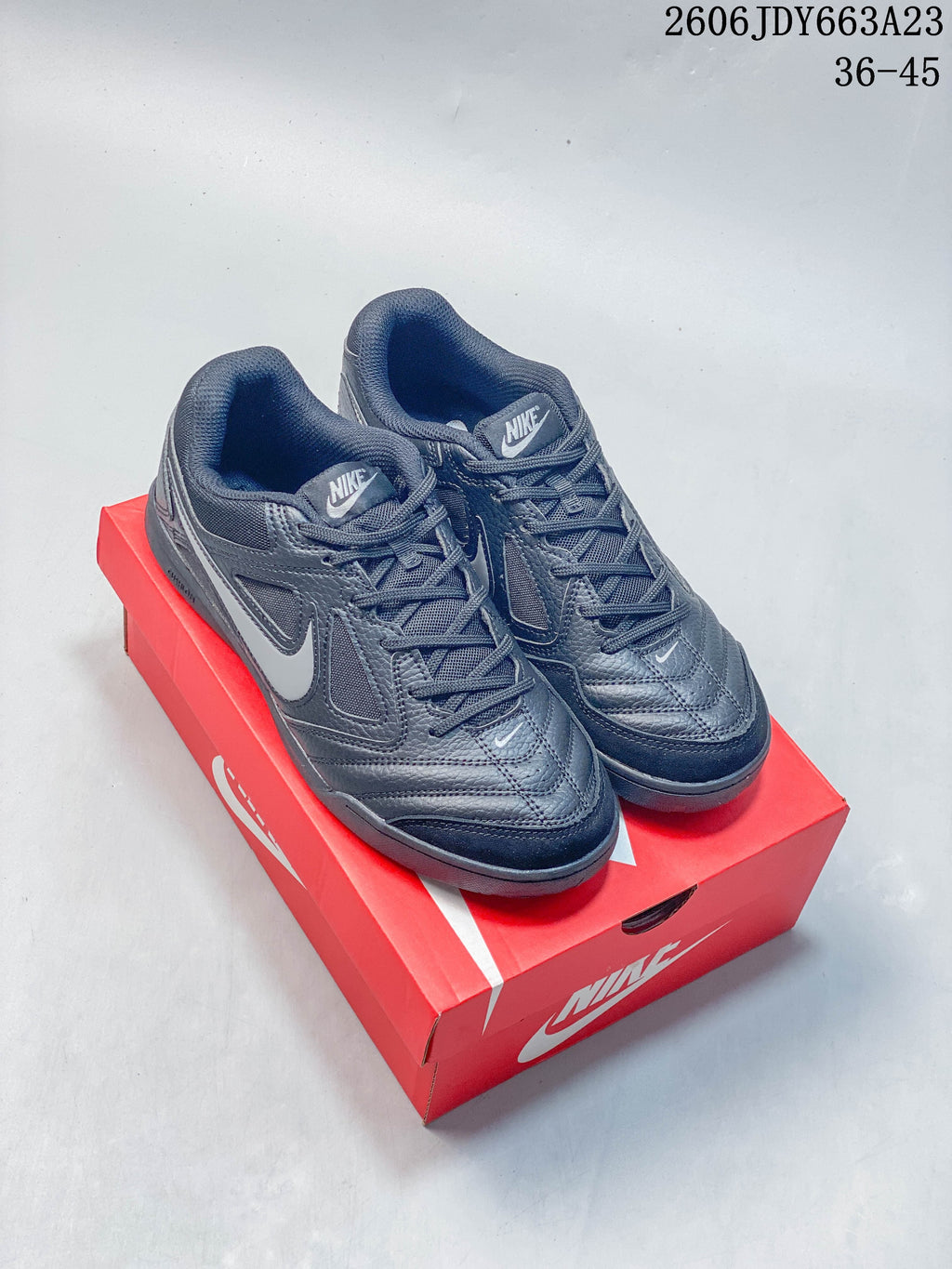 Pair of dark gray Nike Gato sneakers with white accents and dark outsoles