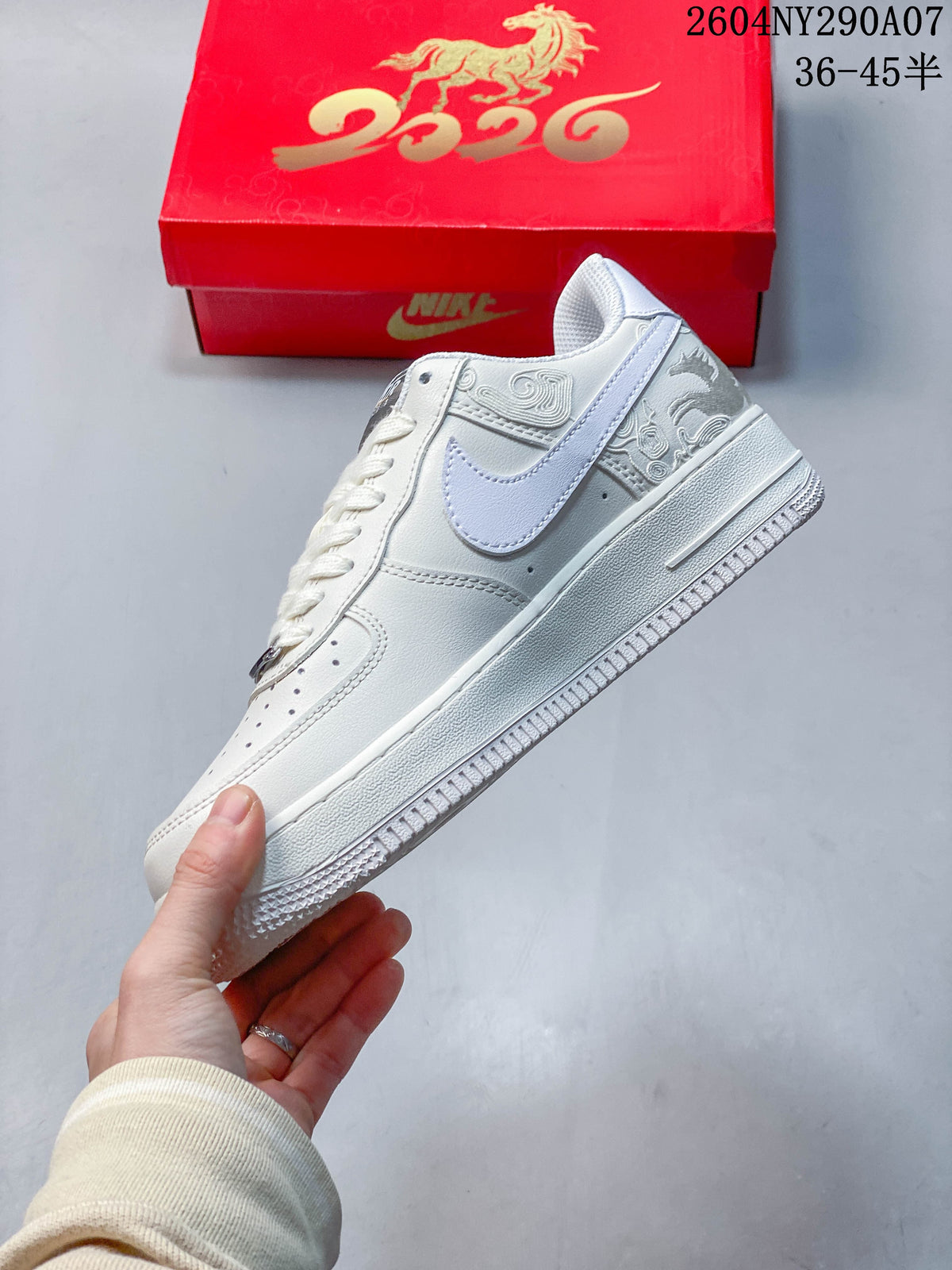 Side view of the white low-top Air Force 1 with embroidered detailing and a pale Swoosh