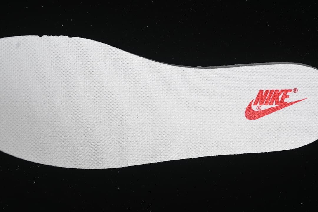 Close-up of a white insole with red Nike branding