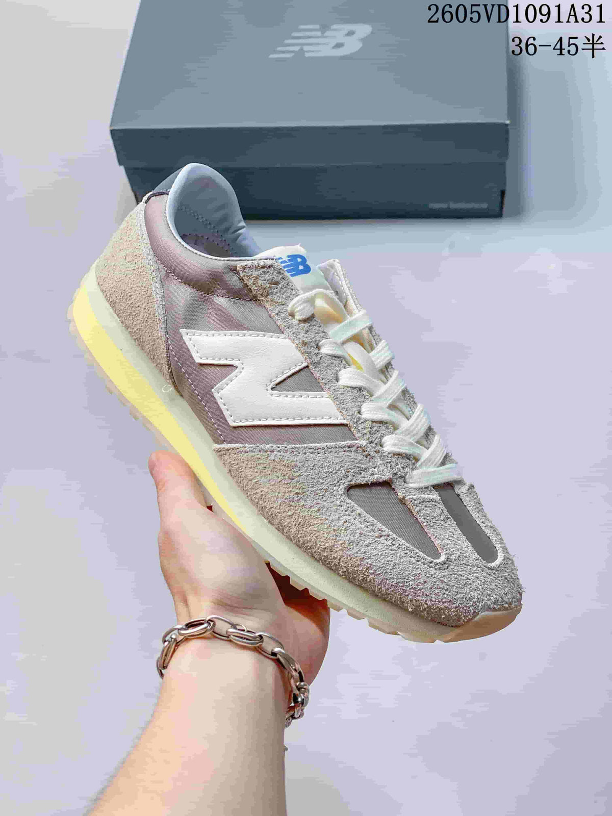 Angled side view of the gray and cream New Balance 471 sneaker