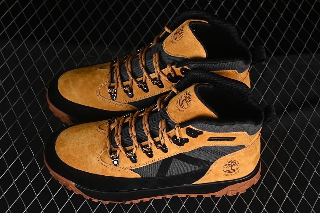 Pair of wheat and black high-top boots viewed from above