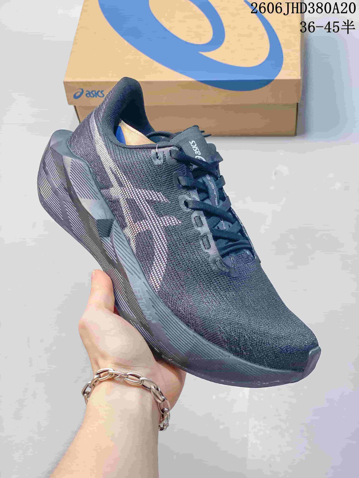 Angled side view of the dark charcoal ASICS NOVABLAST 6 running shoe