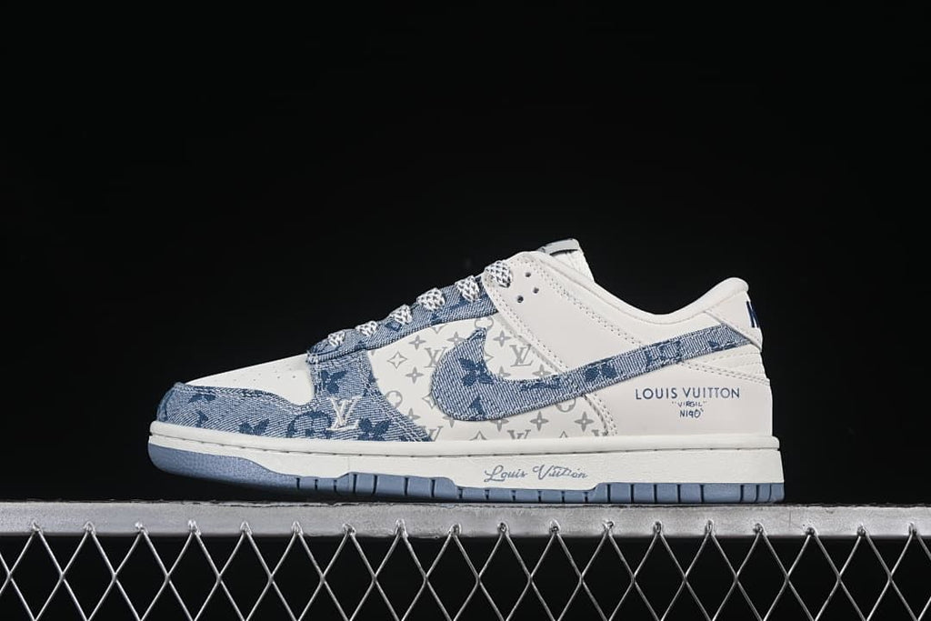 Side view of a white and blue low-top sneaker with denim-style panels and visible Louis Vuitton branding
