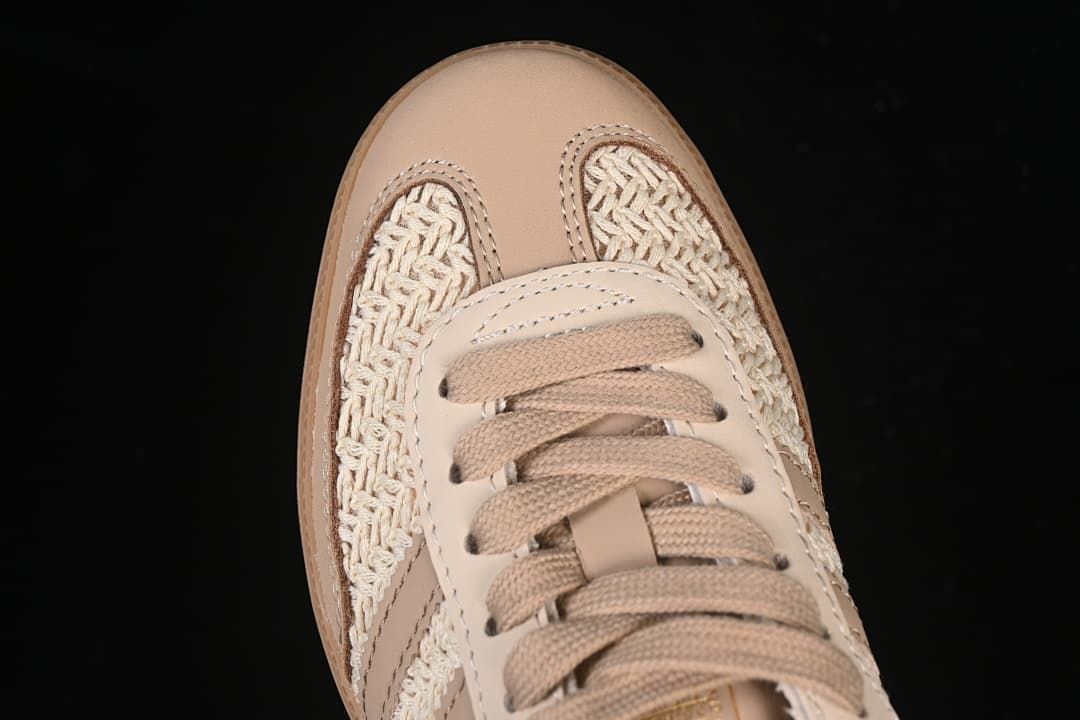 Top-down close-up of the rounded toe, woven panels and laces