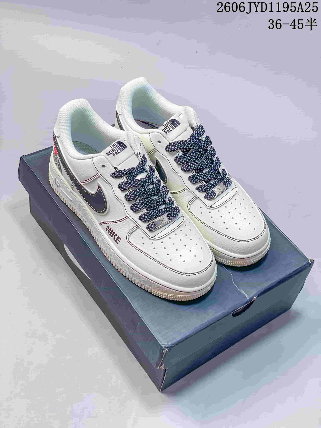 White low-top sneakers with dark patterned laces and side detailing