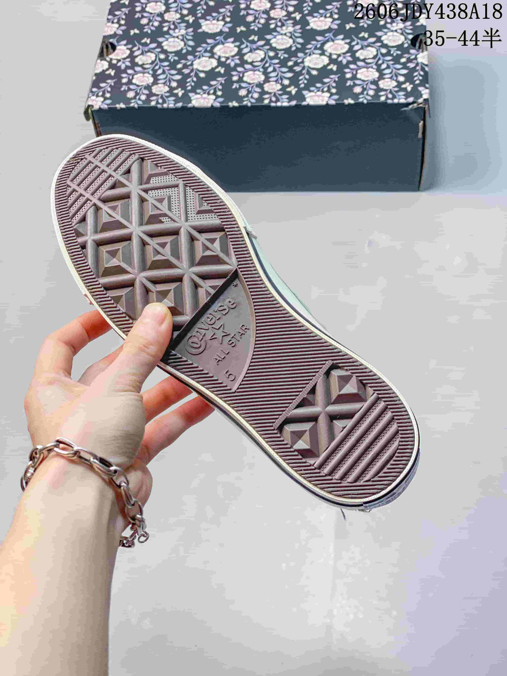 Outsole of the high-top sneaker showing a Converse All Star tread design
