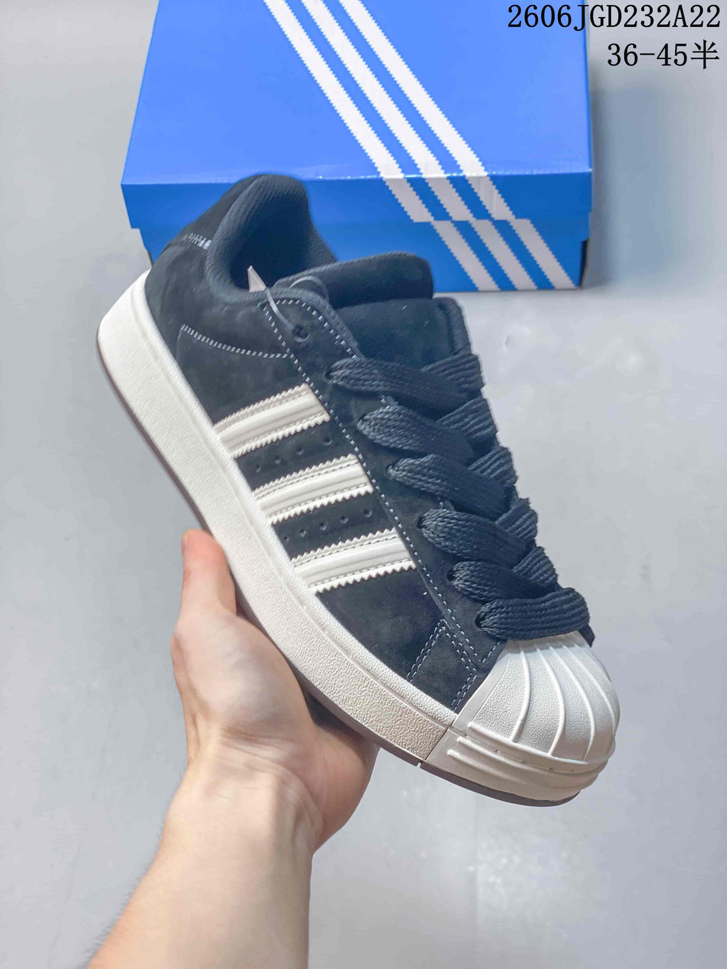 Angled side view highlighting the contrasting stripes, laces, shell toe, and flat sole