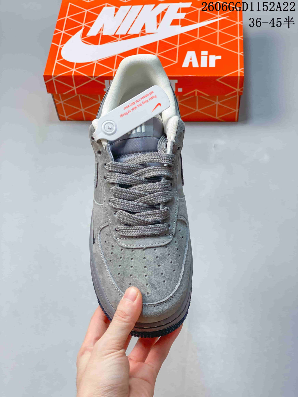 Front view of the grey sneaker showing its perforated toe and lace closure