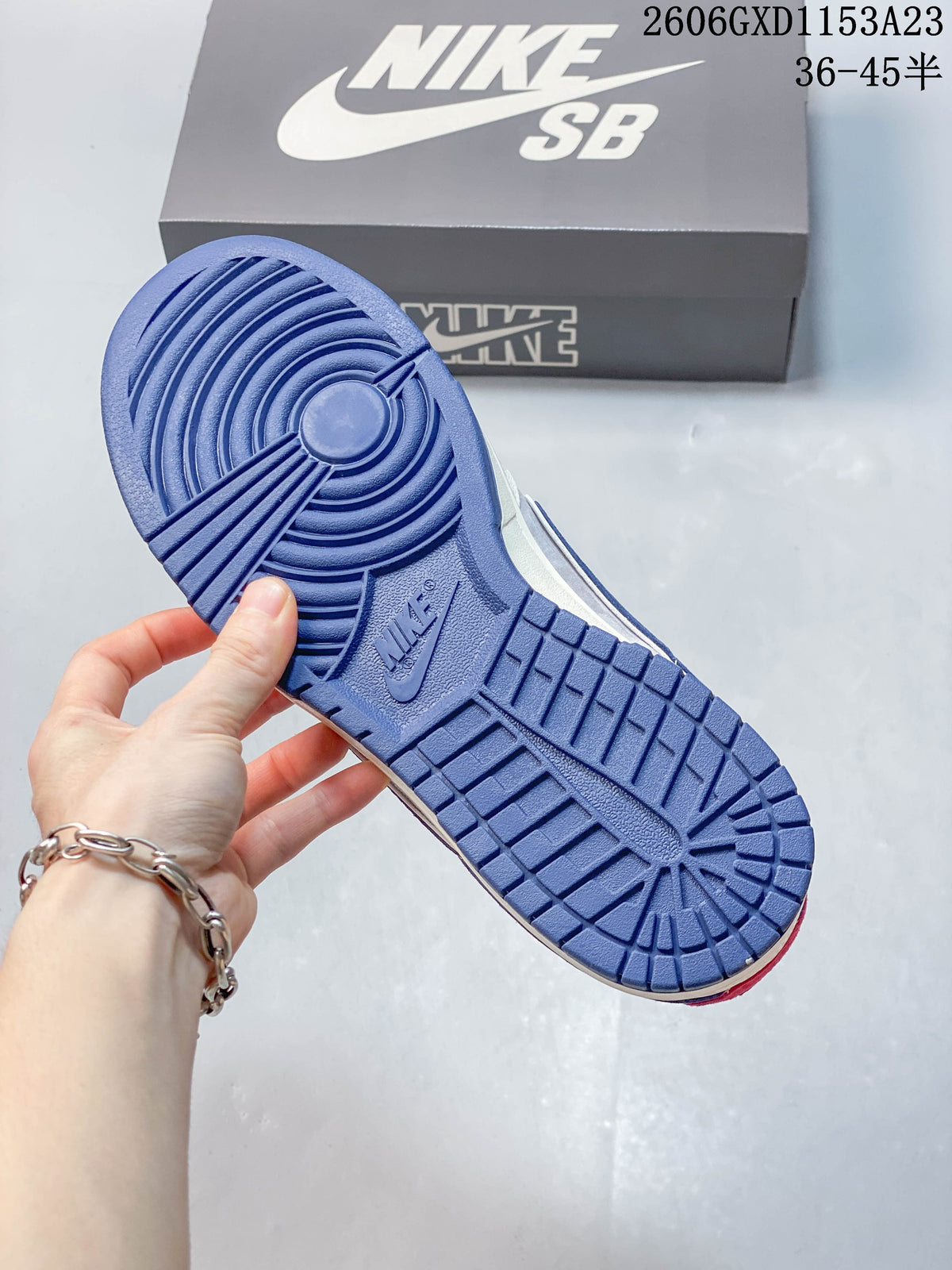 Close-up of the blue patterned outsole on the sneakers.