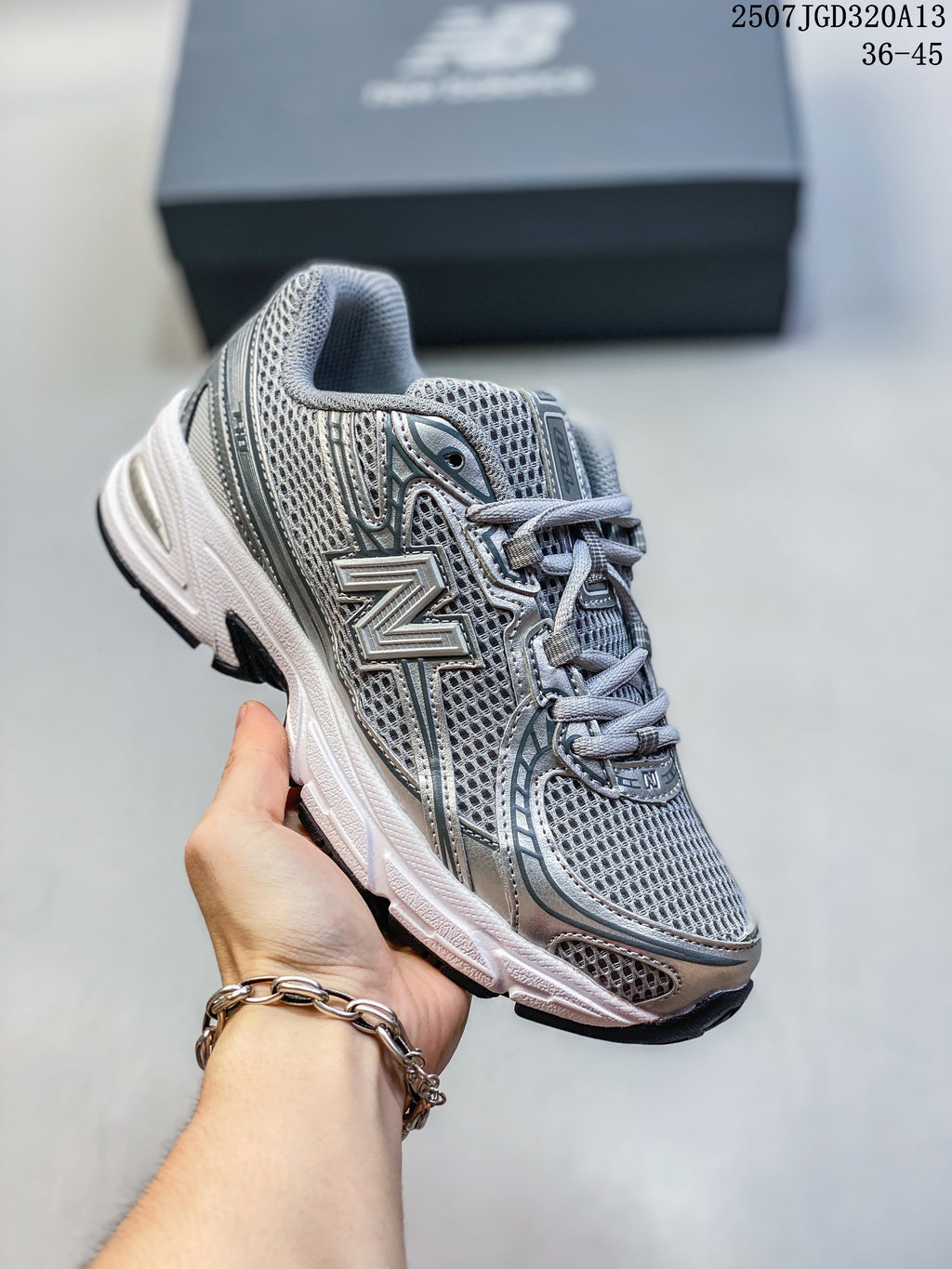 Angled side view of a silver and grey New Balance 740 sneaker