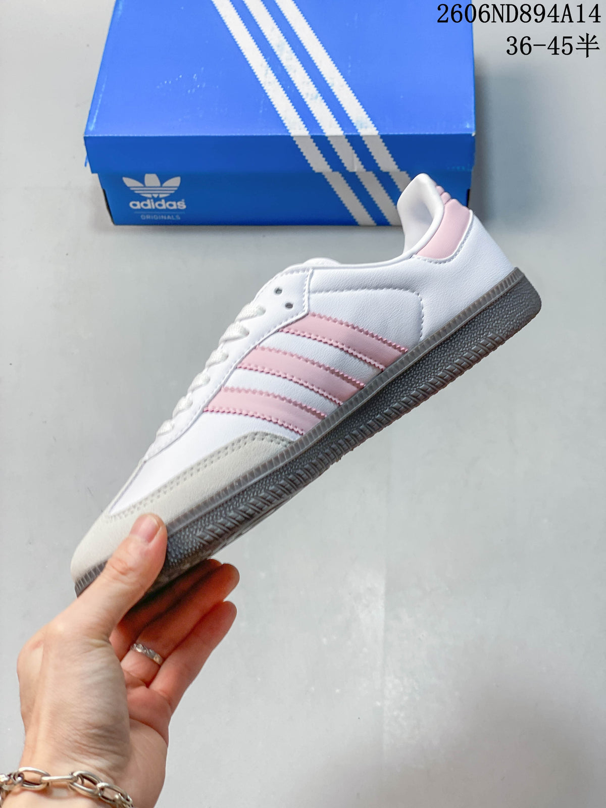 Side view of a white adidas Samba OG sneaker with pink stripes, a light beige toe overlay, and a dark gum-colored outsole.