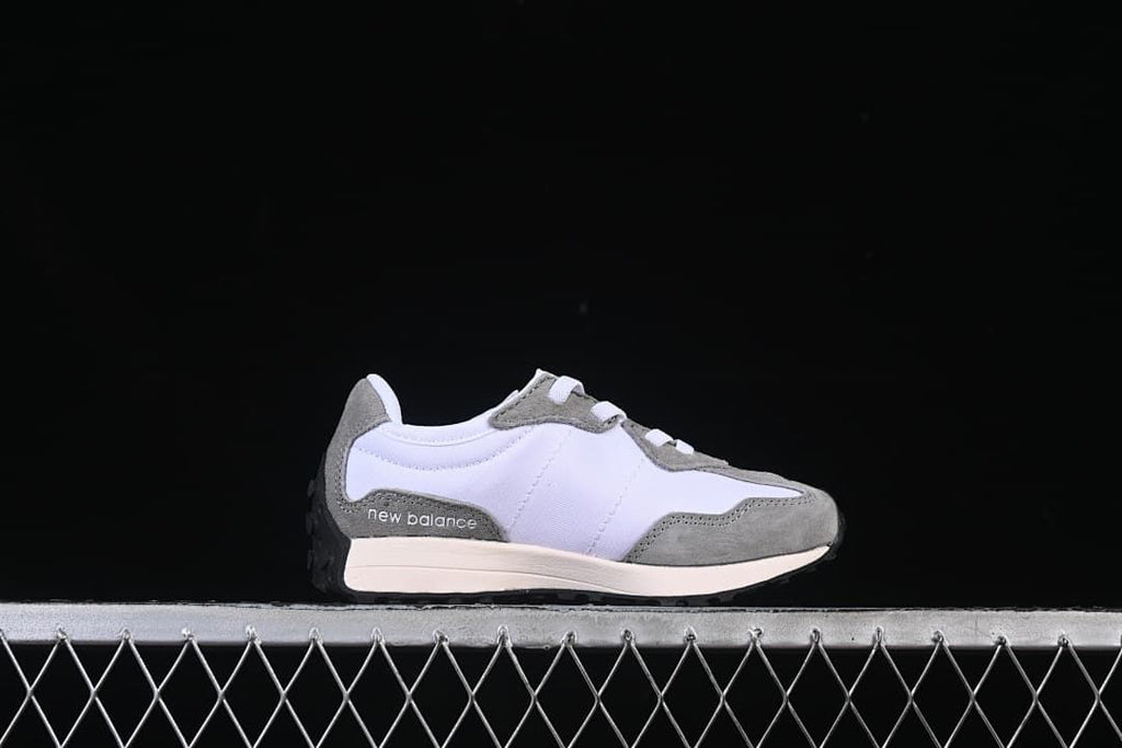 Side view of the sneaker showing layered panels and a light-colored midsole.