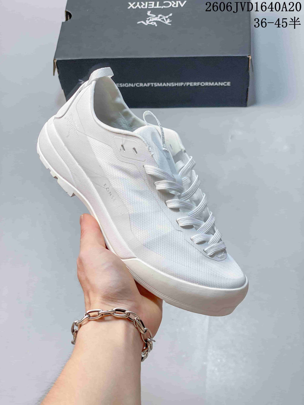 Angled side view of the white shoe showing its upper, laces, and heel pull loop; image overlay lists sizes 36–45.5.