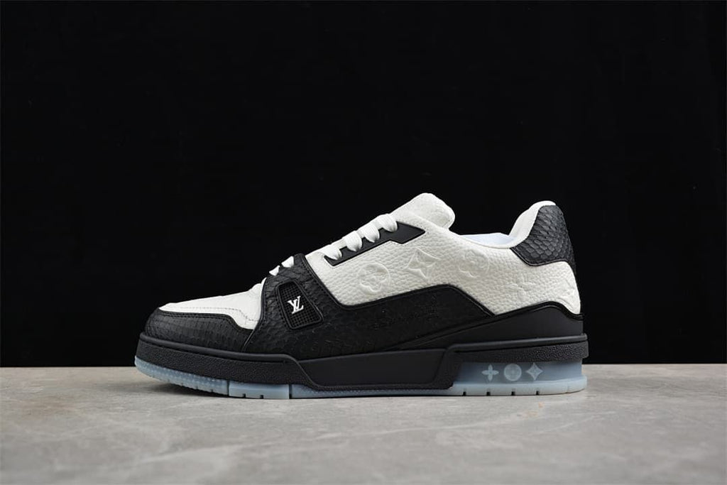 Side profile of a black and white sneaker against a dark backdrop.