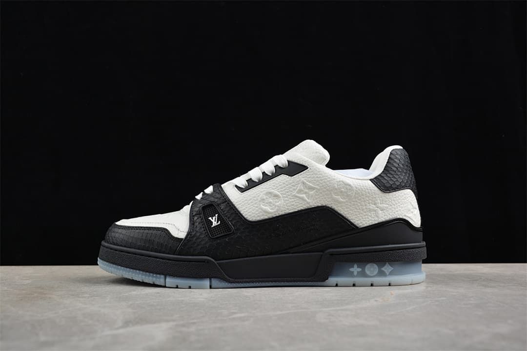 Side profile of a black and white sneaker against a dark backdrop.