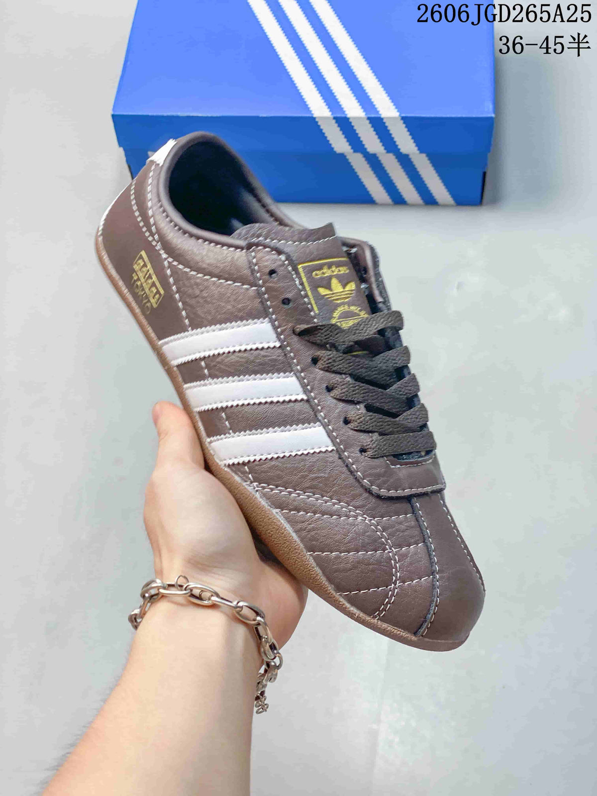 Side view of a brown adidas Originals Tokyo sneaker with white stripes and gum-colored sole