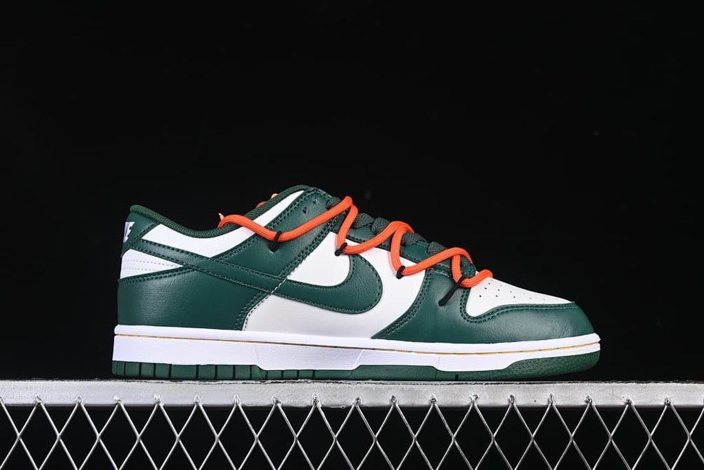 Side profile of the green and white sneaker with orange laces