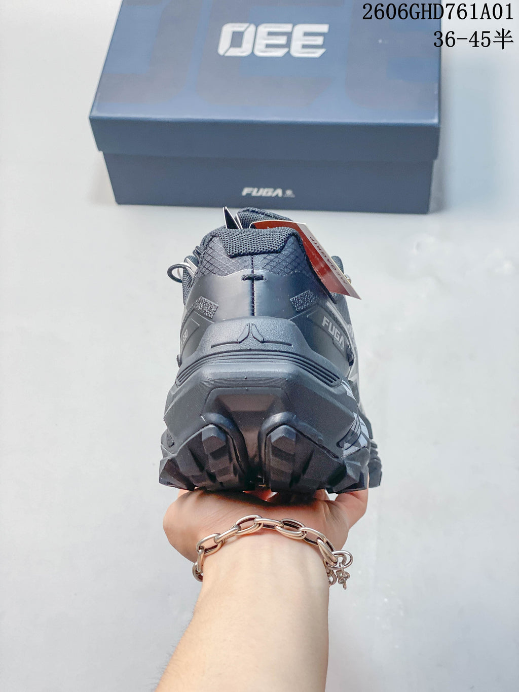 Rear view of a charcoal gray trail running shoe