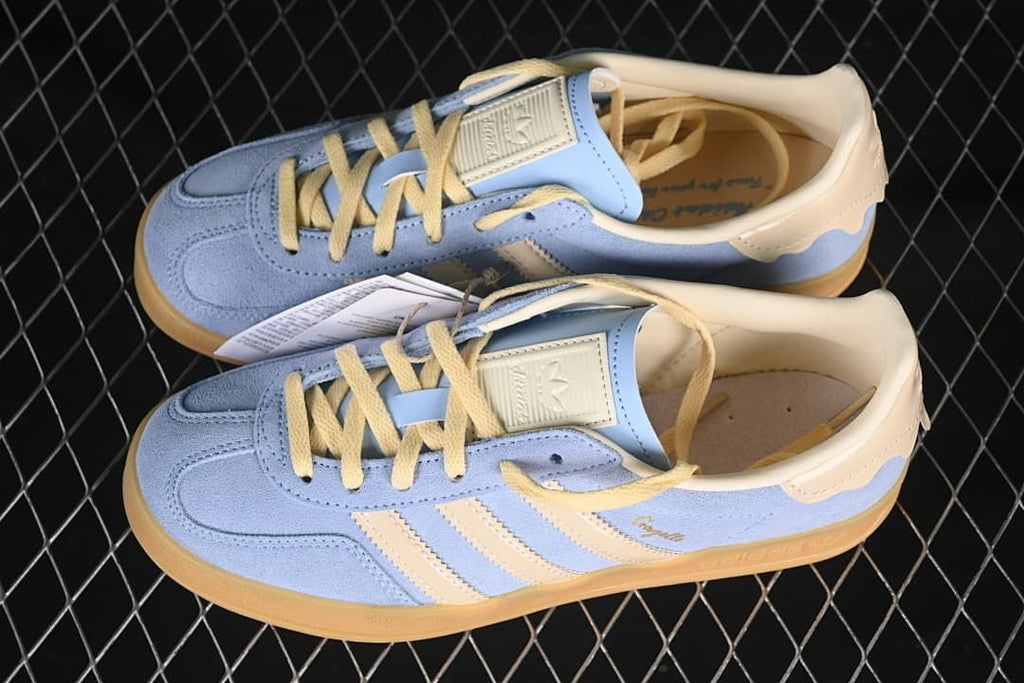 Pair of light blue and cream Gazelle Indoor sneakers shown from above