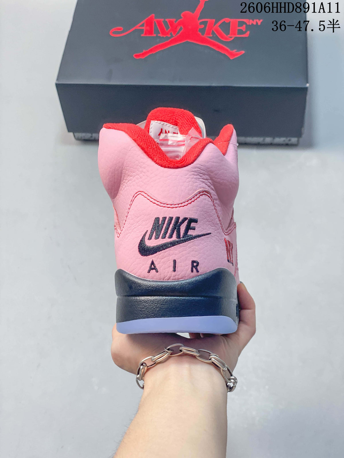Rear view of the pink sneaker showing Nike Air branding and a dark-colored heel section.