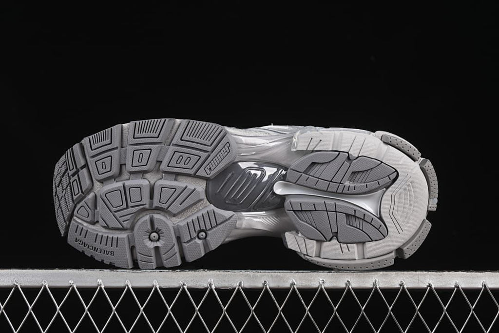 Underside view showing the geometric tread pattern and outsole branding.