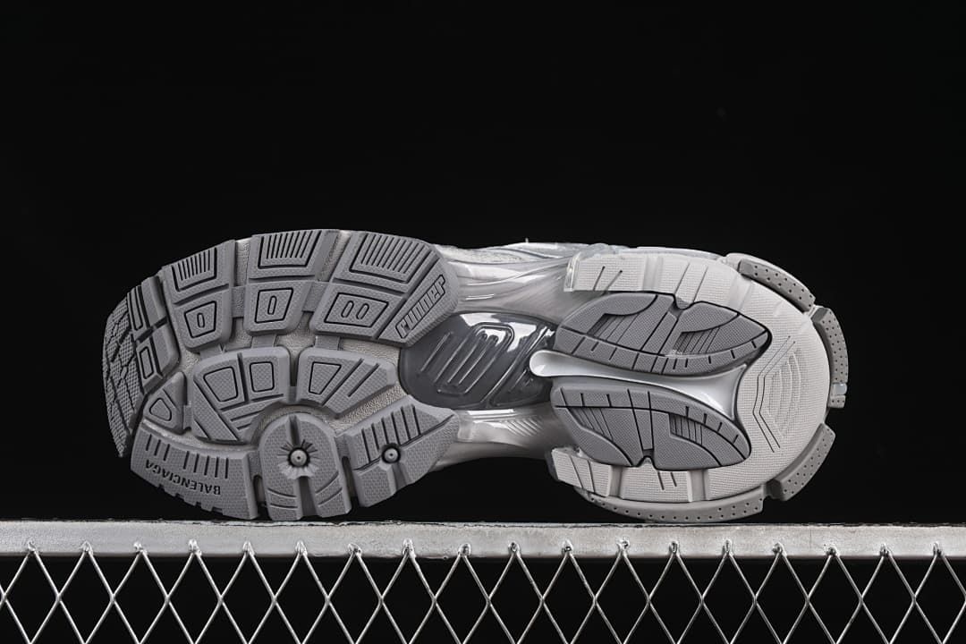 Underside view showing the geometric tread pattern and outsole branding.