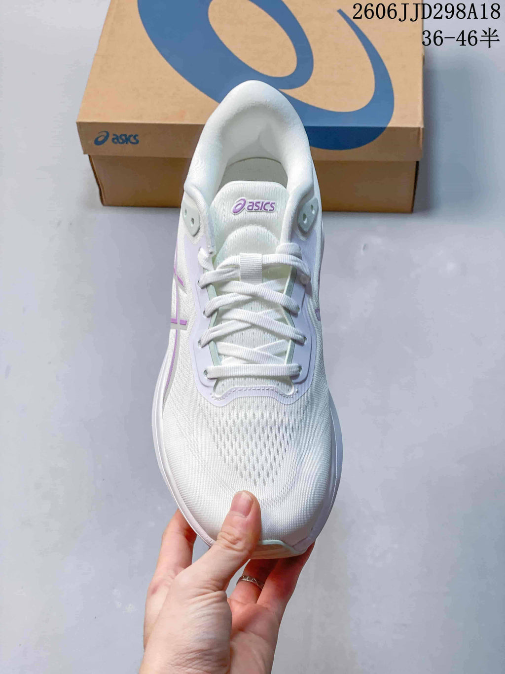 Top view of a white ASICS running shoe showing the laces and mesh-look upper