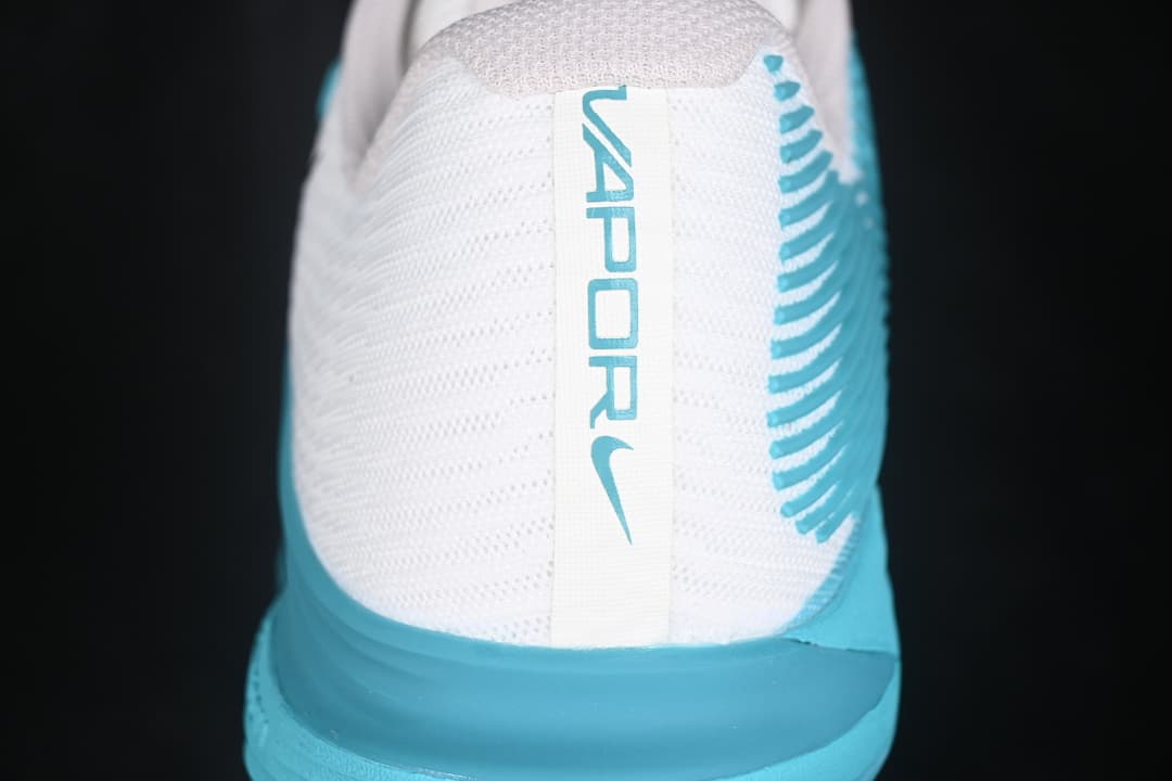 Rear view showing the white heel panel and aqua Vapor branding.