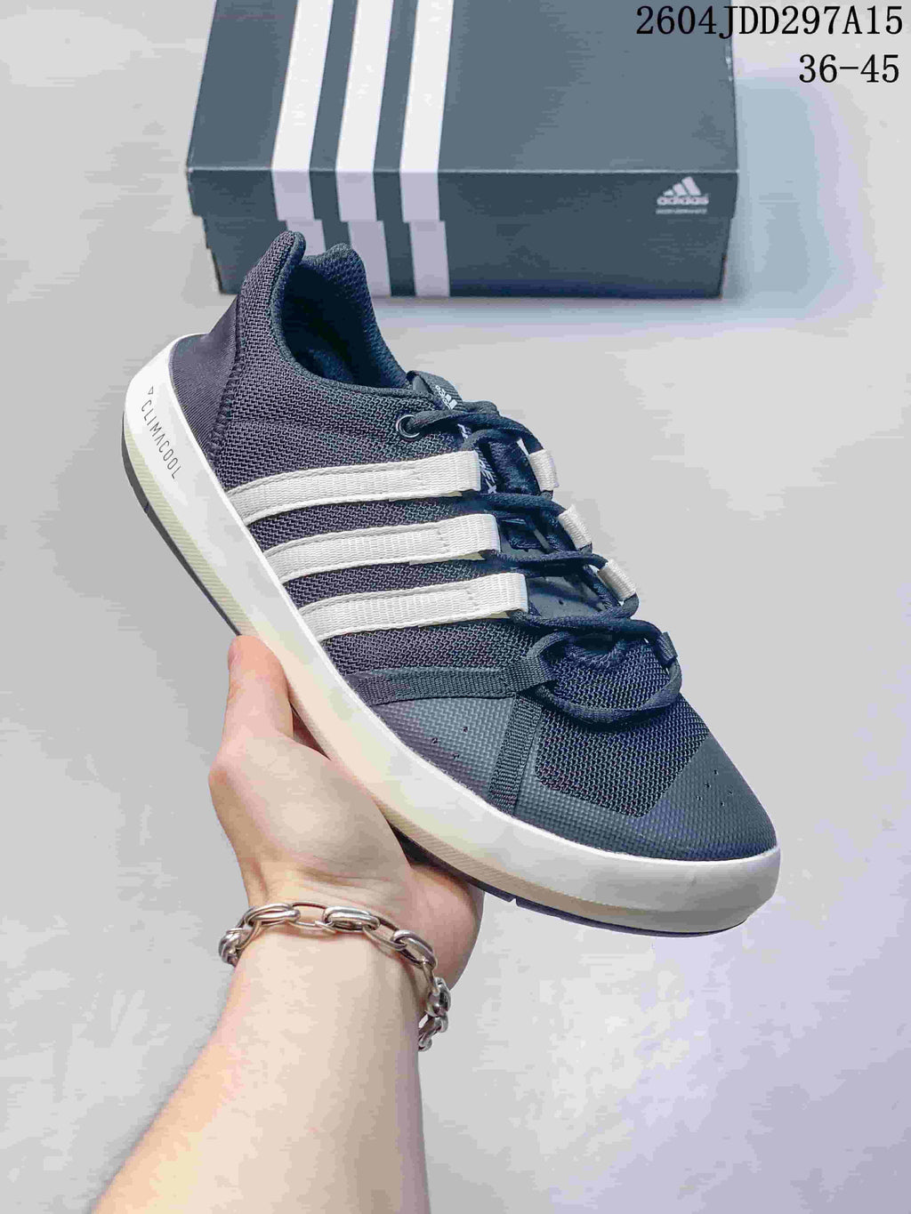Angled side view of the adidas Terrex CC Boat shoe in dark gray and white