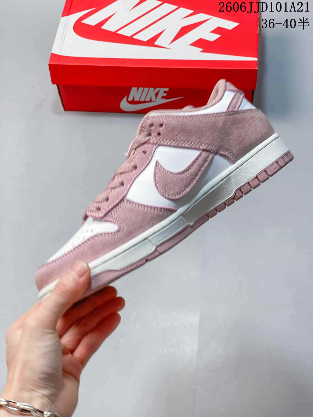 Side view showing pink overlays, white panels, and the Swoosh detail.